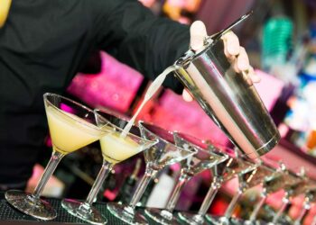 Barman preparing cocktails at a club.
