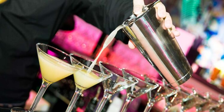 Barman preparing cocktails at a club.