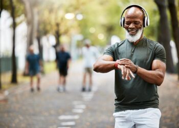 Workout and welness with a senior male tracking his health via smart watch.