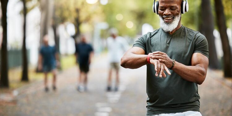 Workout and welness with a senior male tracking his health via smart watch.